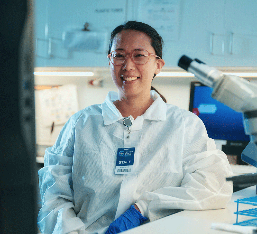 Woman in medical laboratory office smiling at the camera