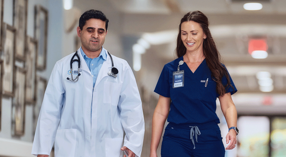 Memorial Health System providers walking in hallway corridor and talking