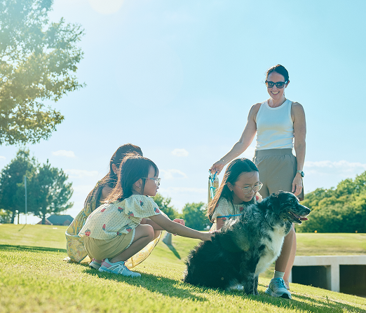 Mom with three children and a dog in the park
