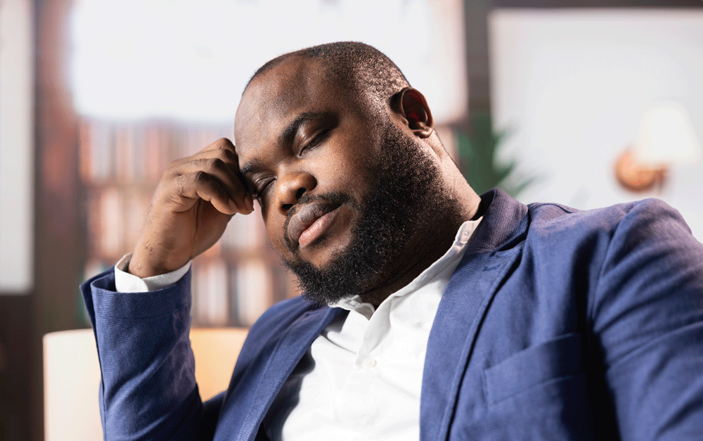 Adult man falling asleep at work