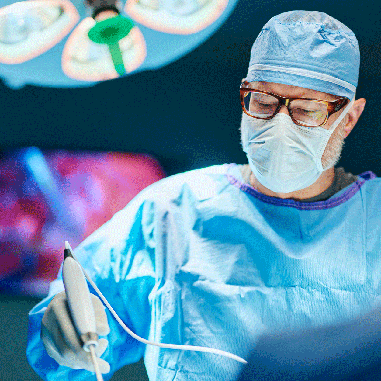 Surgeon holding surgical tool during operation