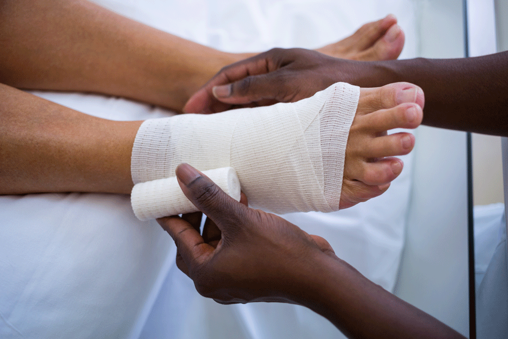 Closeup of doctor bandaging patient's foot