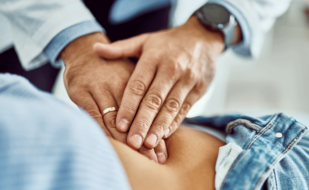 Doctor hands examining kidney area of abdomen Doctor hands examining kidney area of abdomen