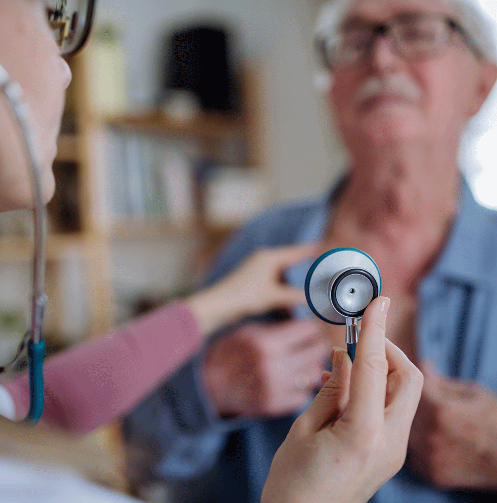 Doctor holding stethoscope getting ready to listen to man's heartbeat