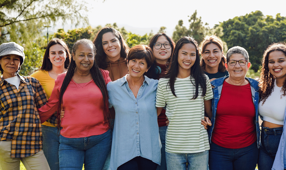 Group of diverse woman standing outside smiling