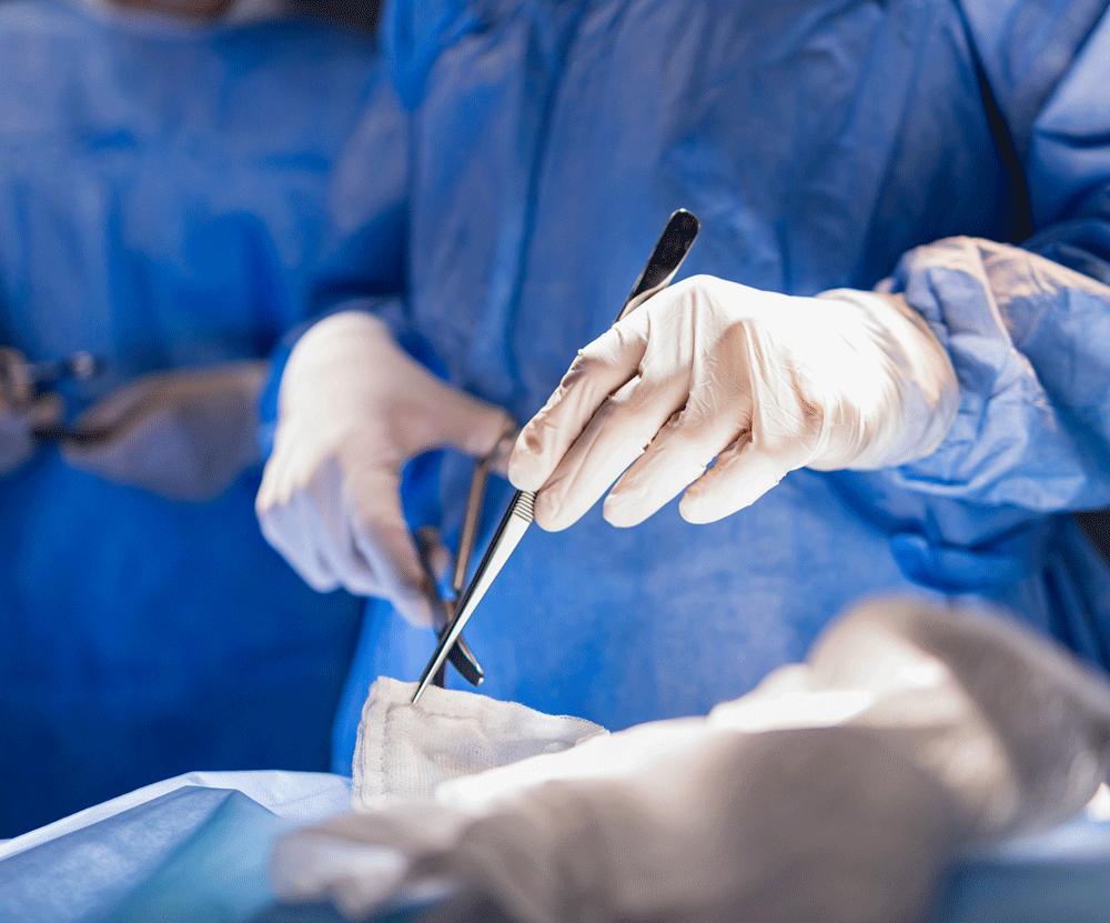 Surgeon holding surgical tool in hand Surgeon holding surgical tool in hand
