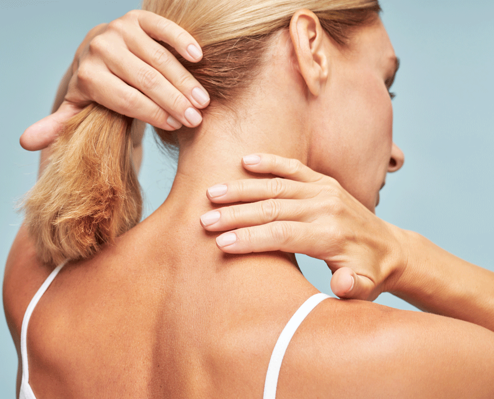 Rear view of woman rubbing neck
