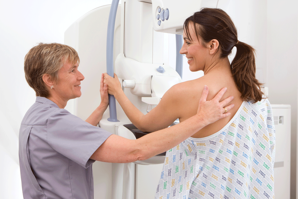 Woman having mammogram in clinic Woman having mammogram in clinic