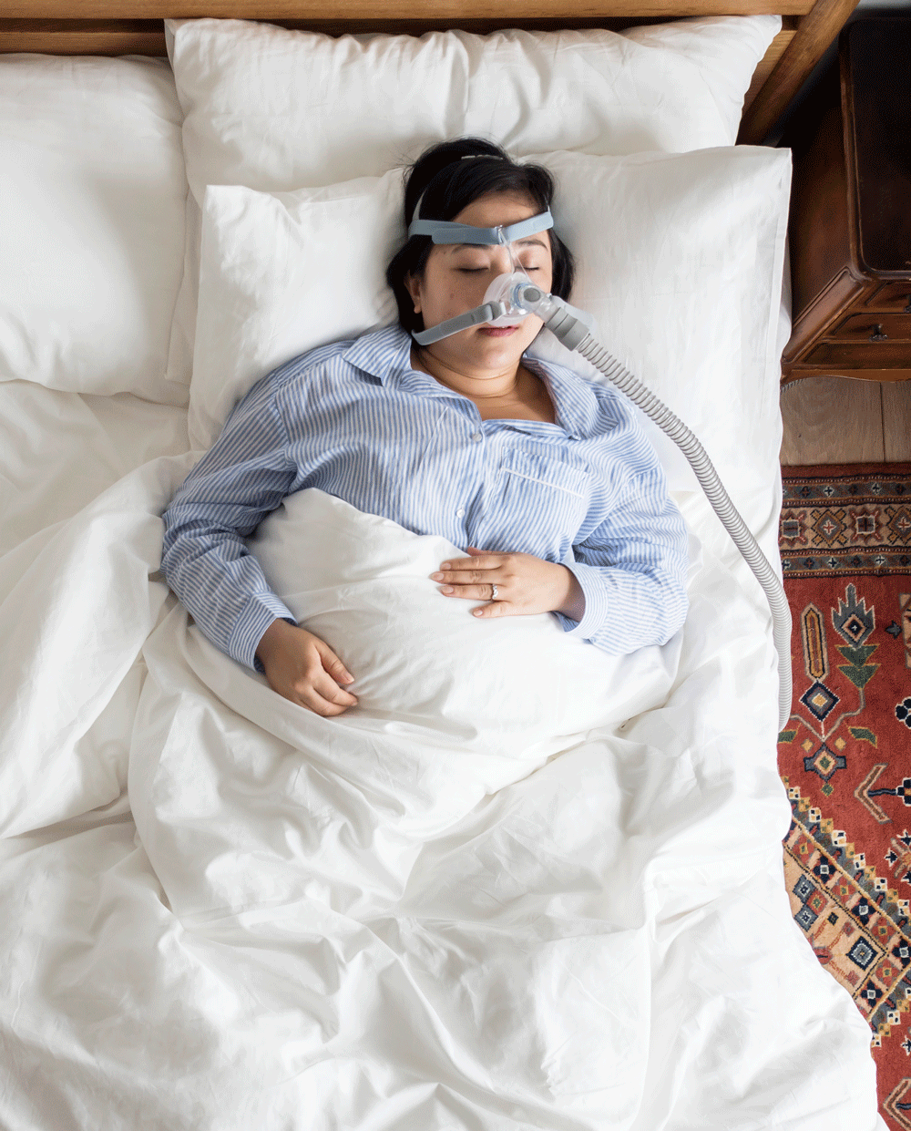 Woman sleeping with CPAP mask